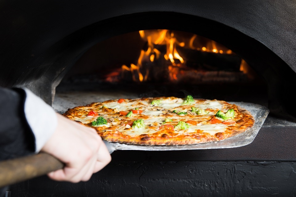 Pizza is moving out at peel from hot slove