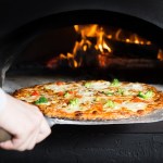 Pizza is moving out at peel from hot slove