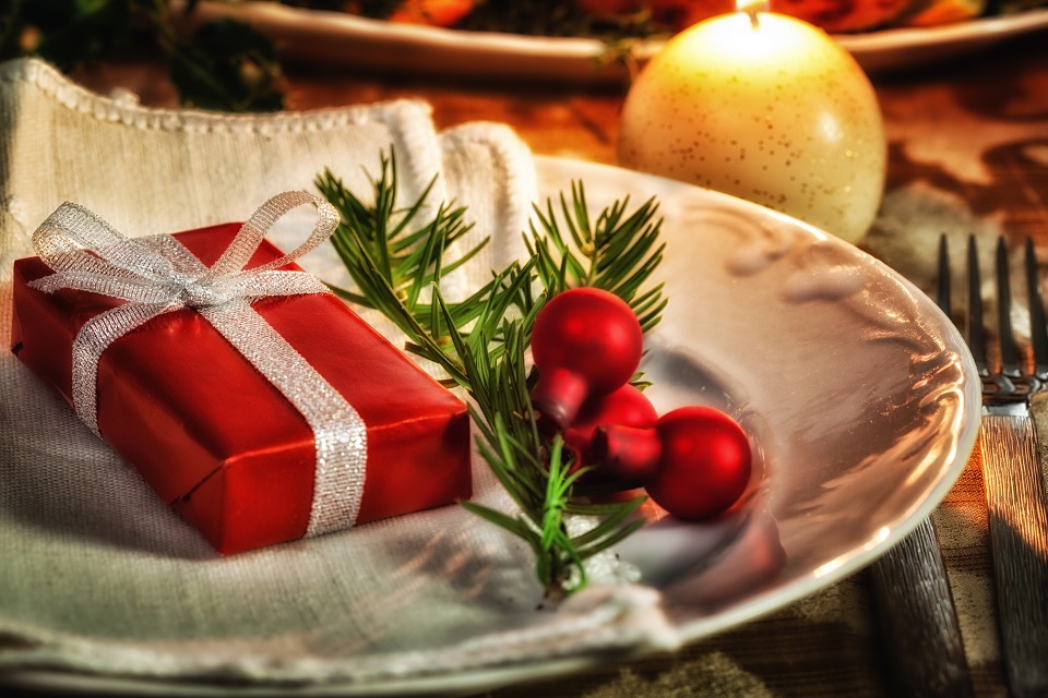 Christmas place setting with gift in a plate