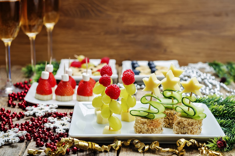Assortment of New Year's snacks and a glass of champagne