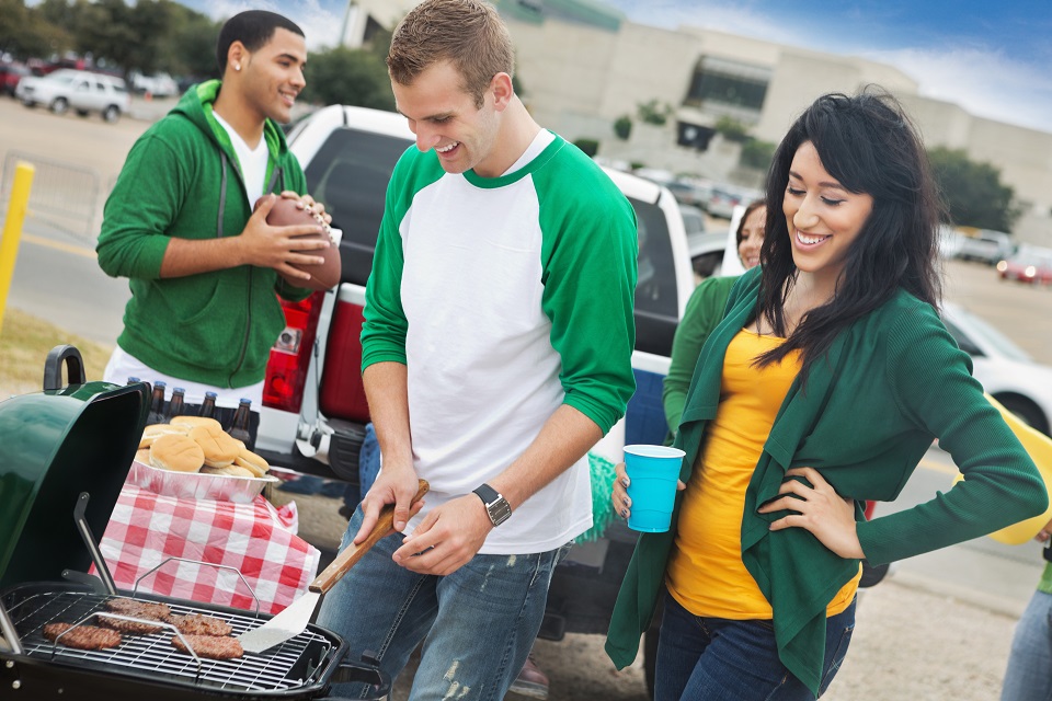 College football fans grilling/tailgating at stadium