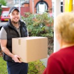 Friendly delivery man delivers parcel