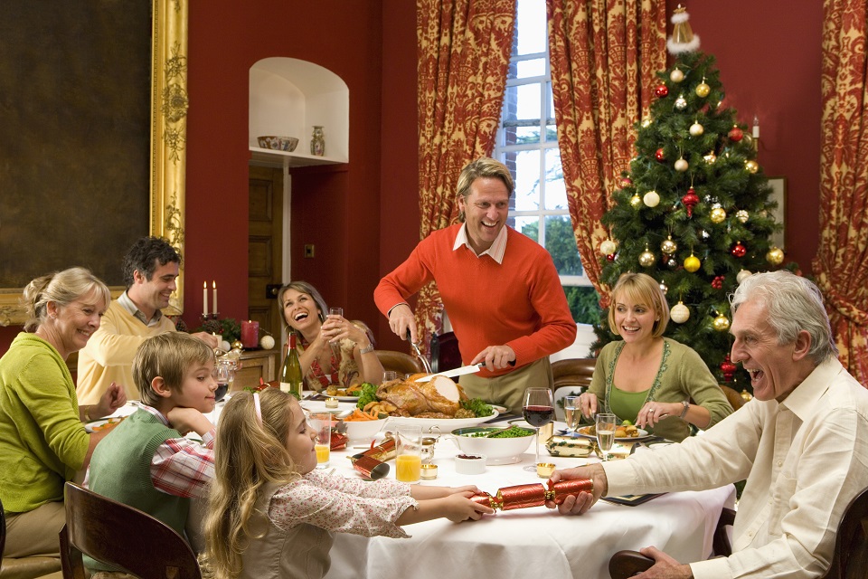 Three generation family and friends having Christmas dinner,