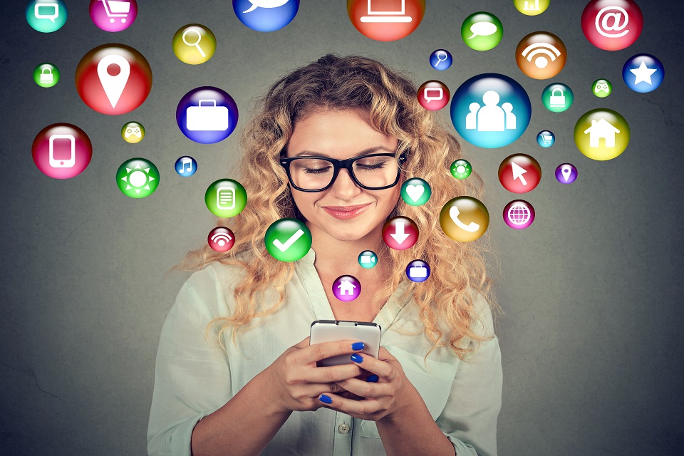 Woman using smartphone social media application icons flying out