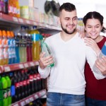 People selecting juice and soda