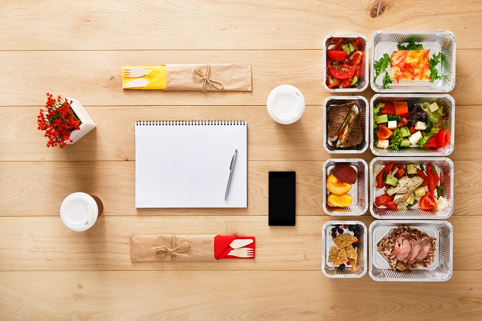 Healthy food take away in boxes, top view at wood