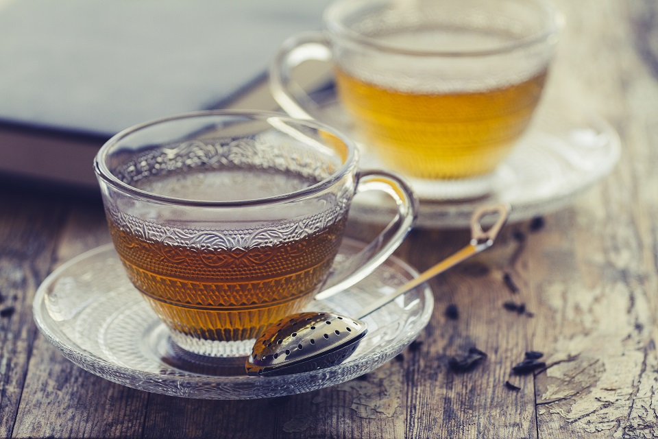 Cup of green tea on a vintage rustic wood blurry or bokeh background
