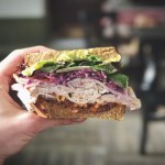 Close-Up Of Hand Holding Sandwich