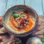 Bowl of hummus topped with whole garbanzo beans