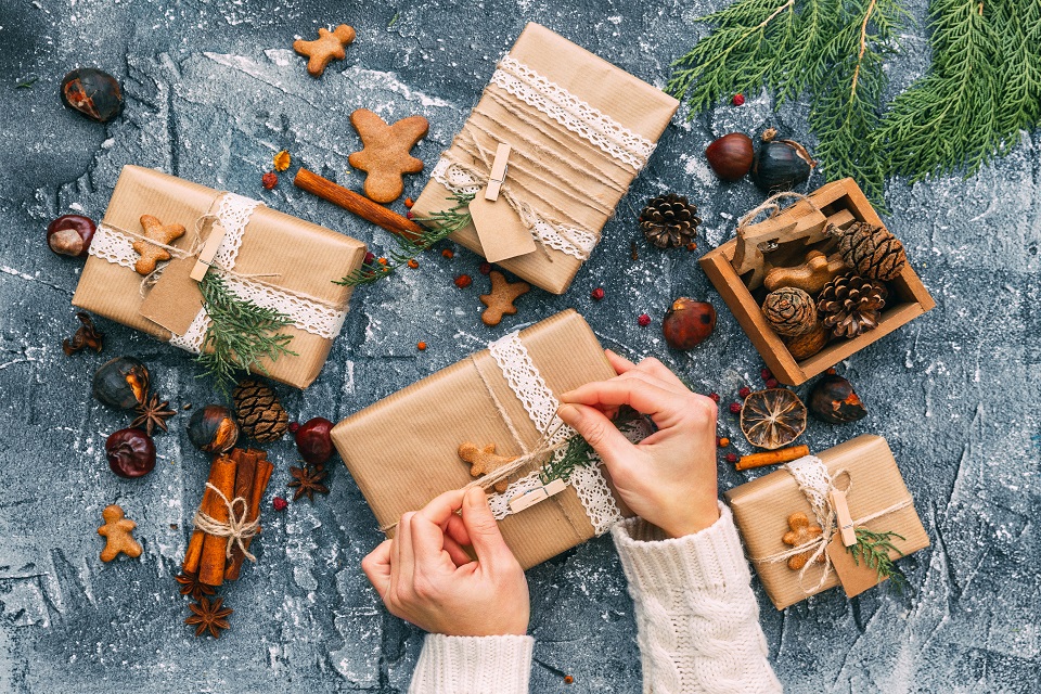 Womans hands wrapping  Christmas gifts