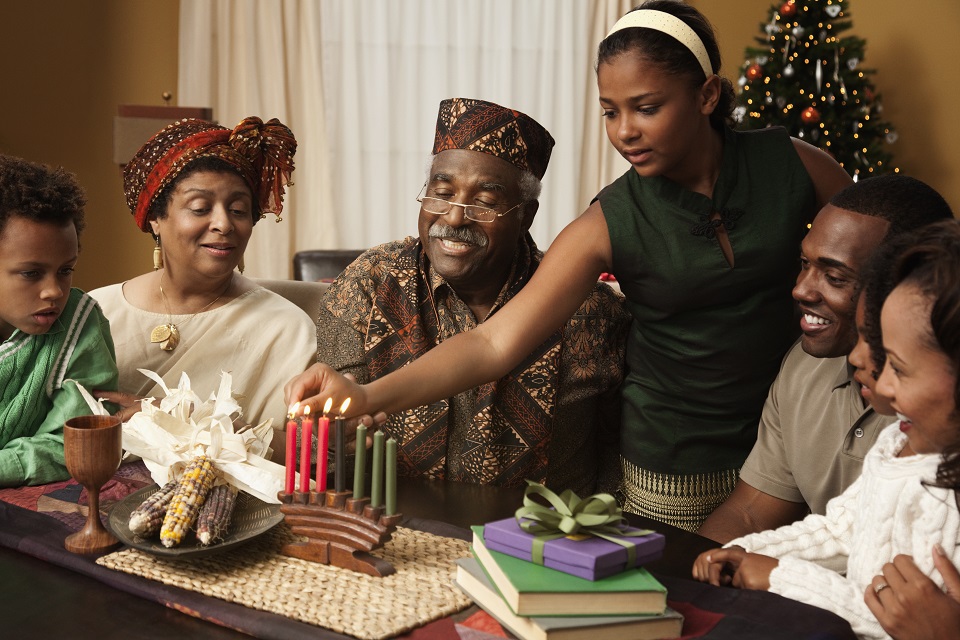 Multi-generation family lighting Kwanzaa candles