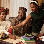 Multi-generation family lighting Kwanzaa candles