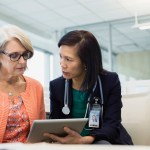 Female doctor showing lab results to older woman