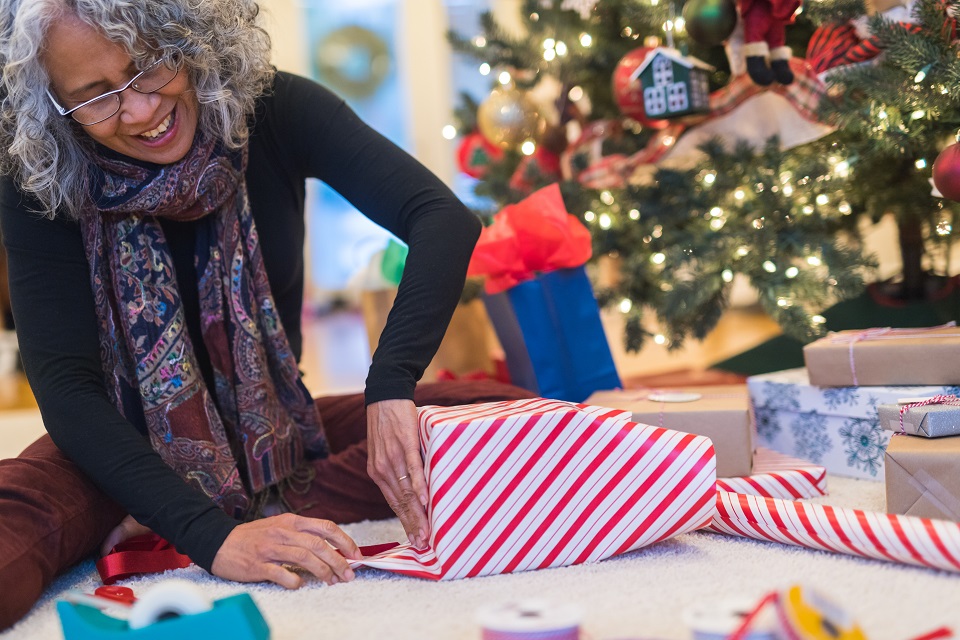 Woman wrapping holiday package