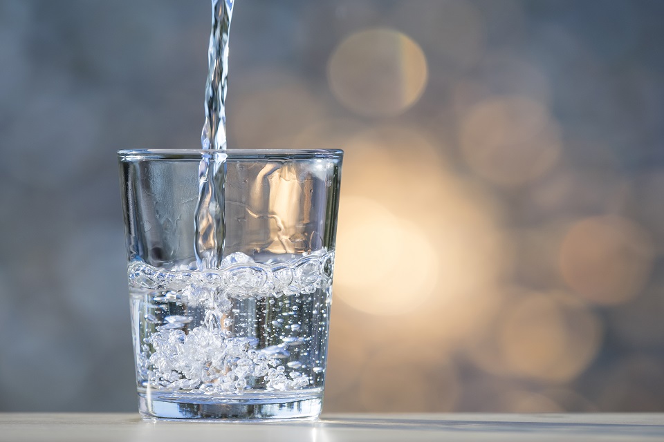 Stream of water filling a glass