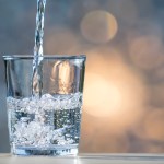 Stream of water filling a glass