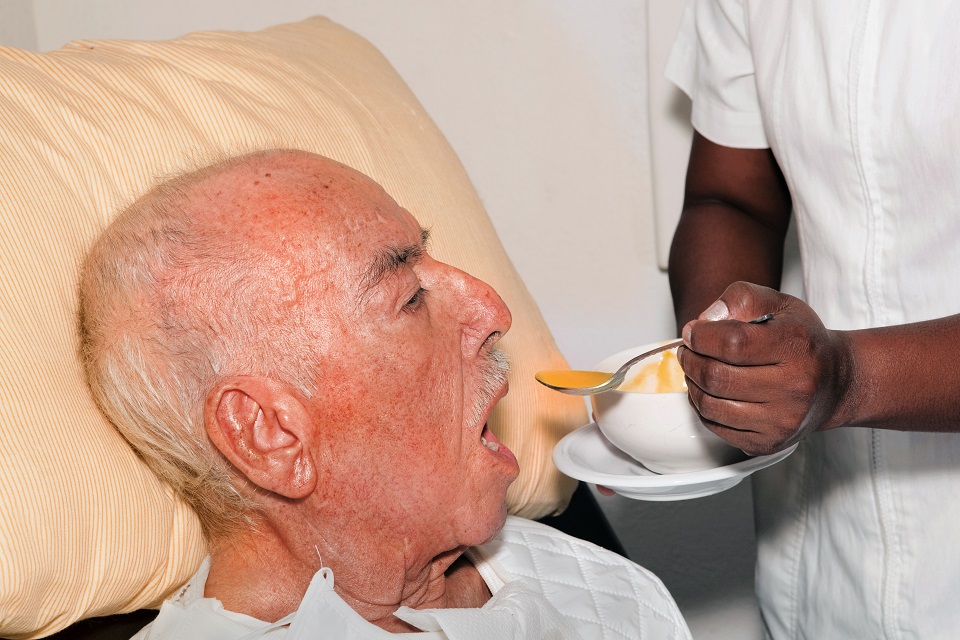 senior male 92 years old being fed by a nurse