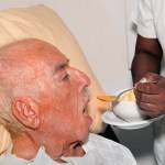 senior male 92 years old being fed by a nurse