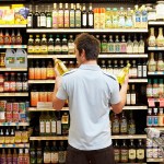 Man in grocery store looking at bottles of cooking oil