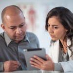 Female Dietitian Shares Information with Patient Using Digital Tablet