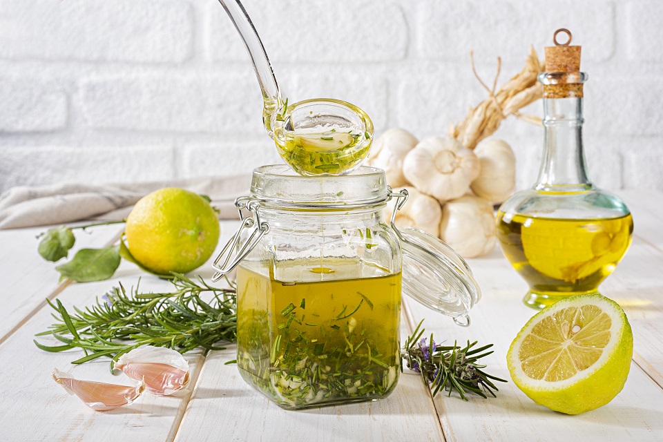 Fresh homemade salad dressing with rosemary, lemon and garlic