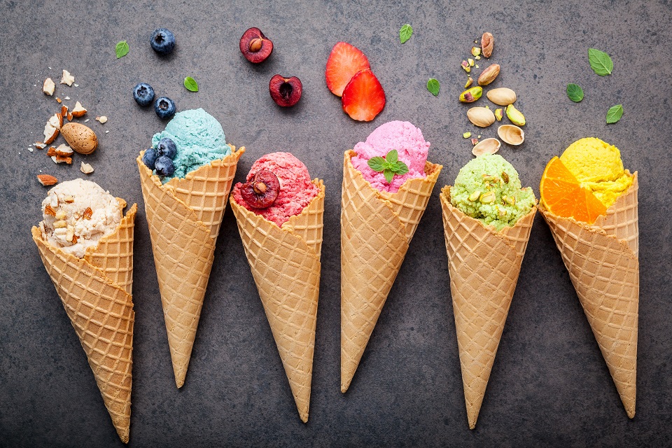 Directly above shot of ice creams with ice cream cones on table