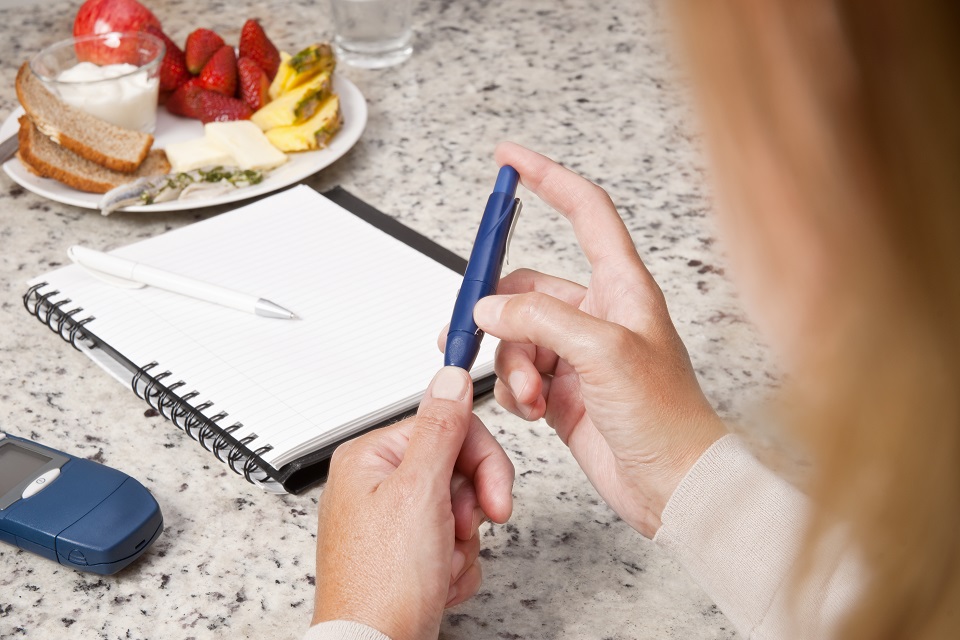 Diabetic woman checking her blood sugar levels