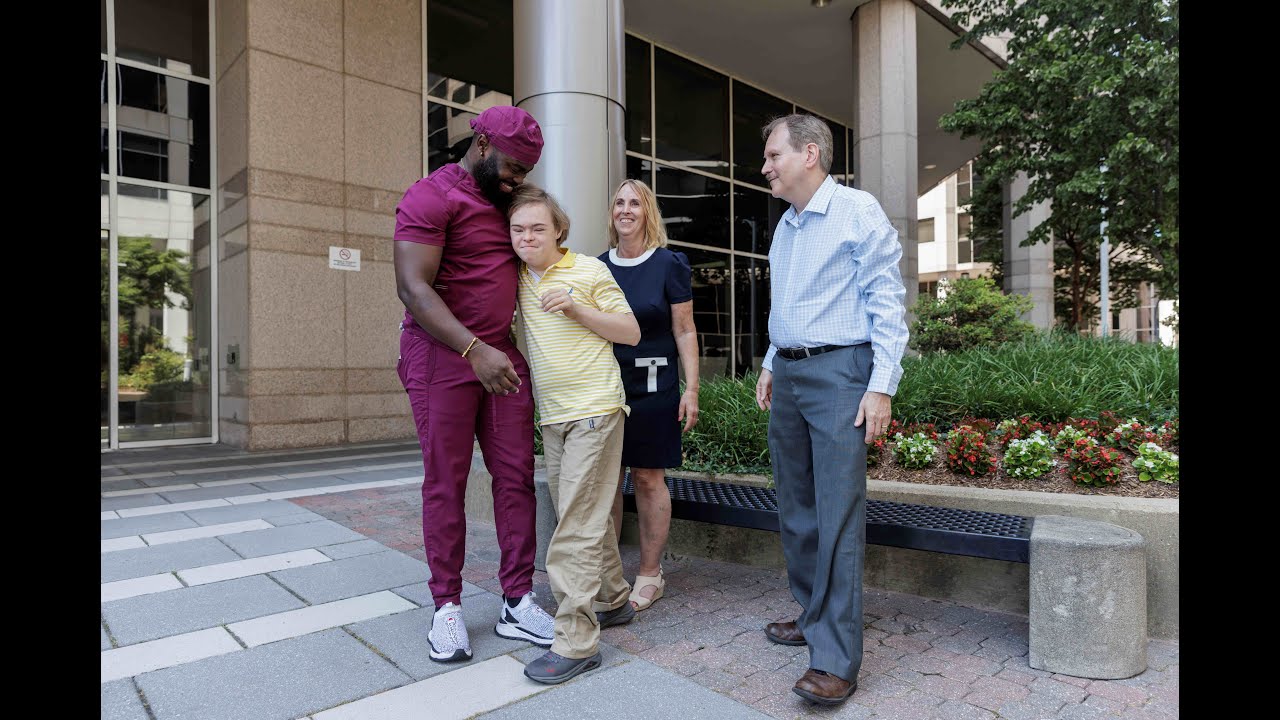 Image of Justin with his nurse and his parents