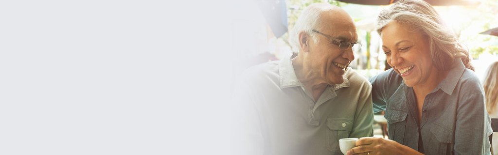 Man and woman smiling sharing coffee