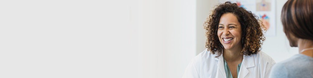 Two people facing each other and smiling