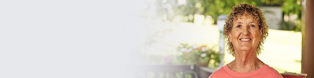 Diane, a PD patient smiling at the camera.