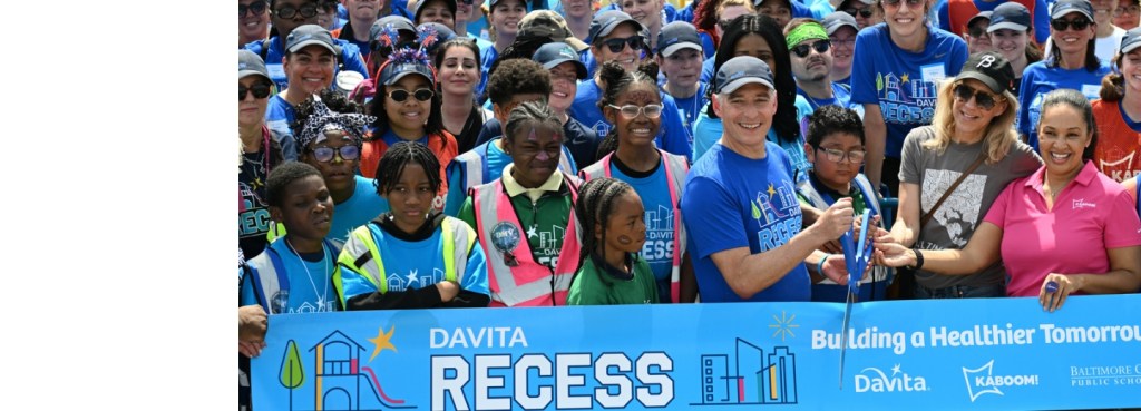 A large group attends a Village Giving ribbon cutting